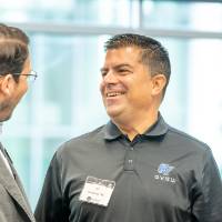 Two Alumni smiling at the event.